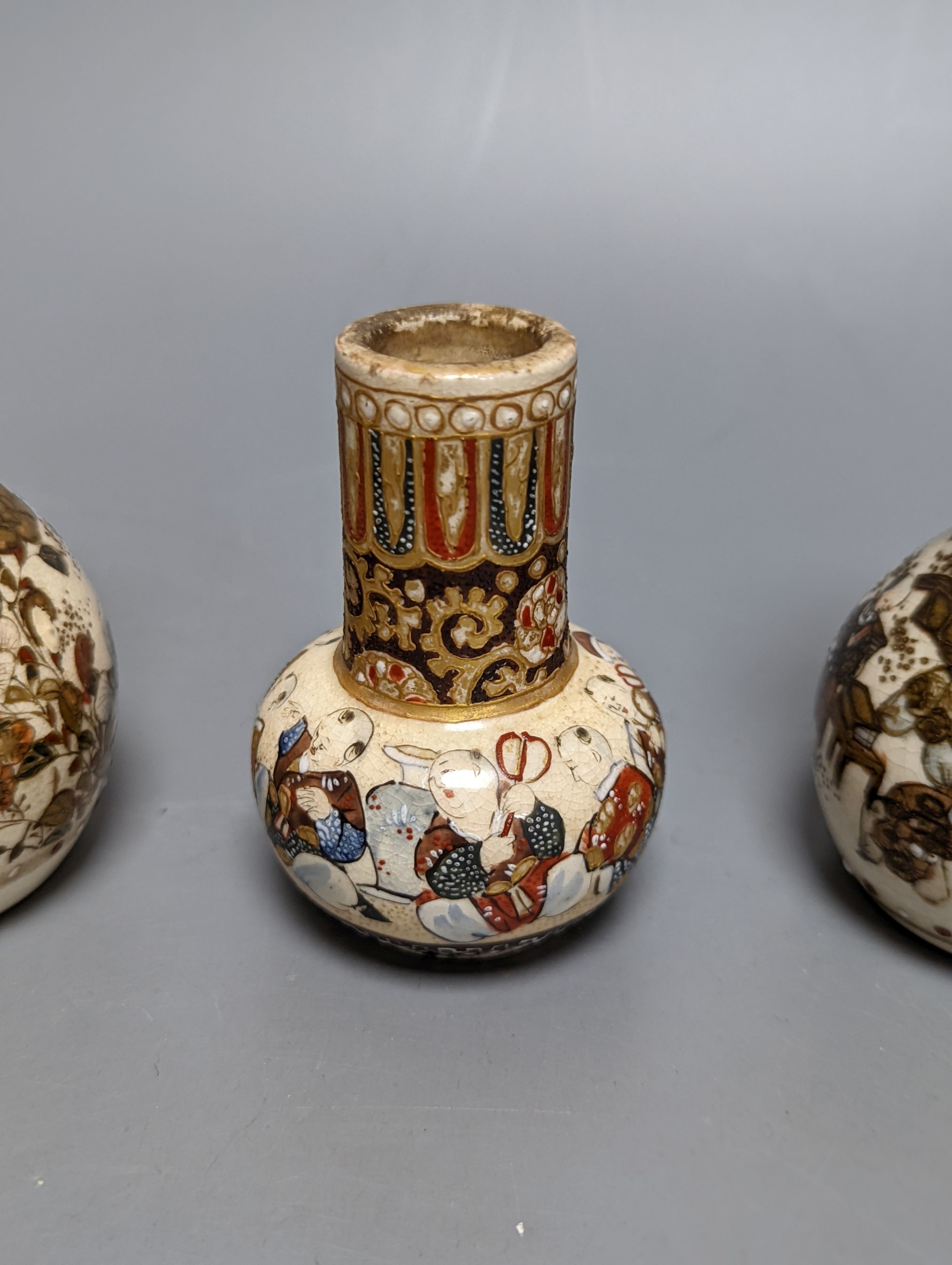 Three Japanese graduated porcelain miniature bowls, a pair of small Satsuma vases and another, pair of vases 12 cms high (6)
